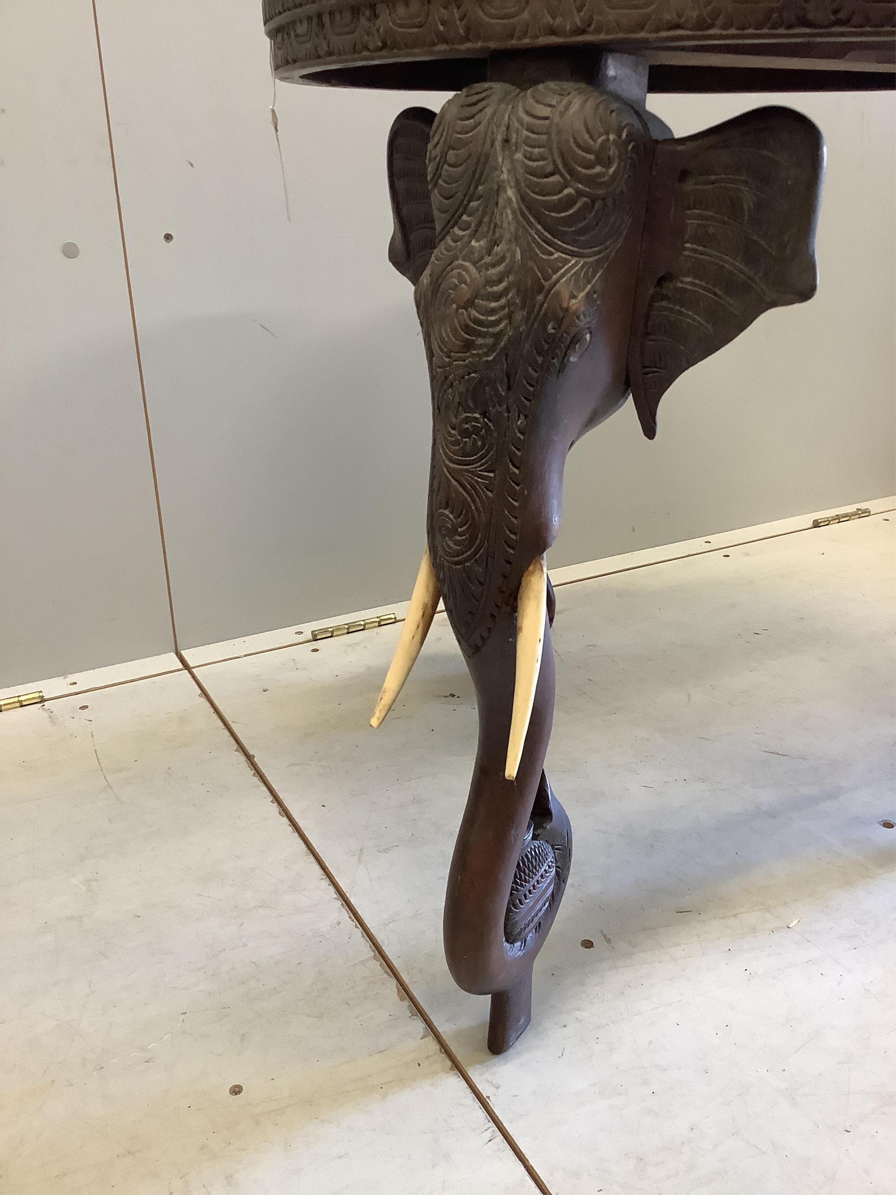 A circular Indian carved hardwood elephant's leg occasional table, diameter 61cm, height 63cm. CITES Submission reference, 8ZTMP59B